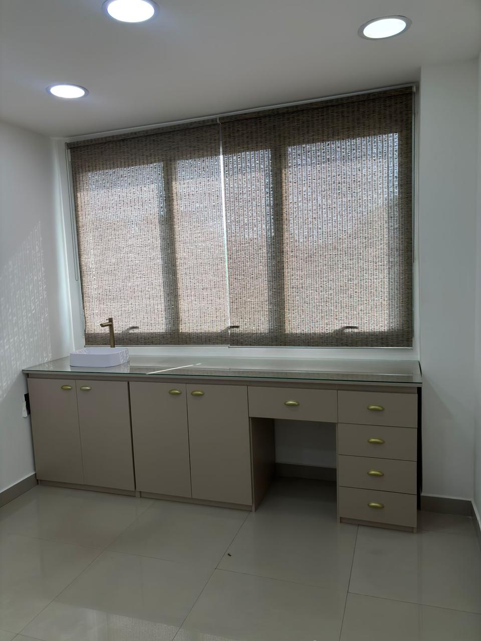 Sala clínica com bancada ampla planejada e gaveteiros